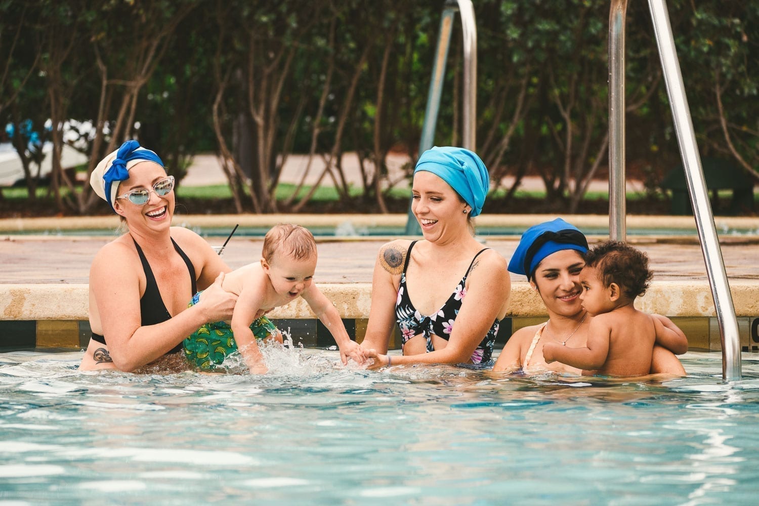 Three women with two children in the pool