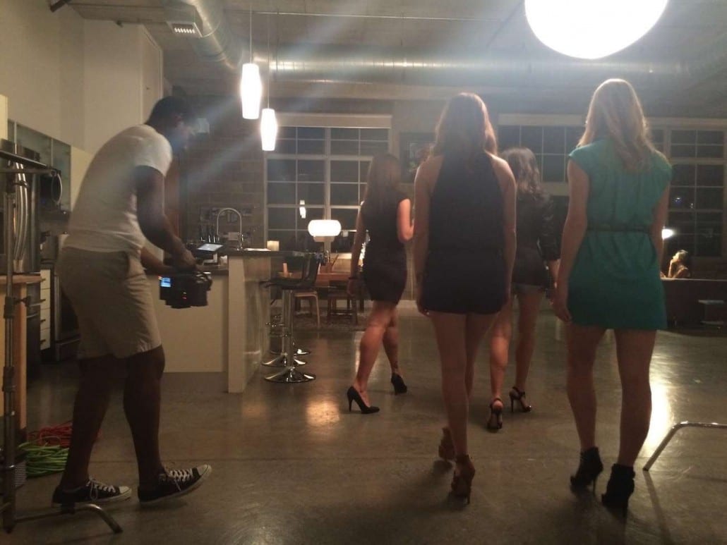 Women being filmed walking away from a video cameraman