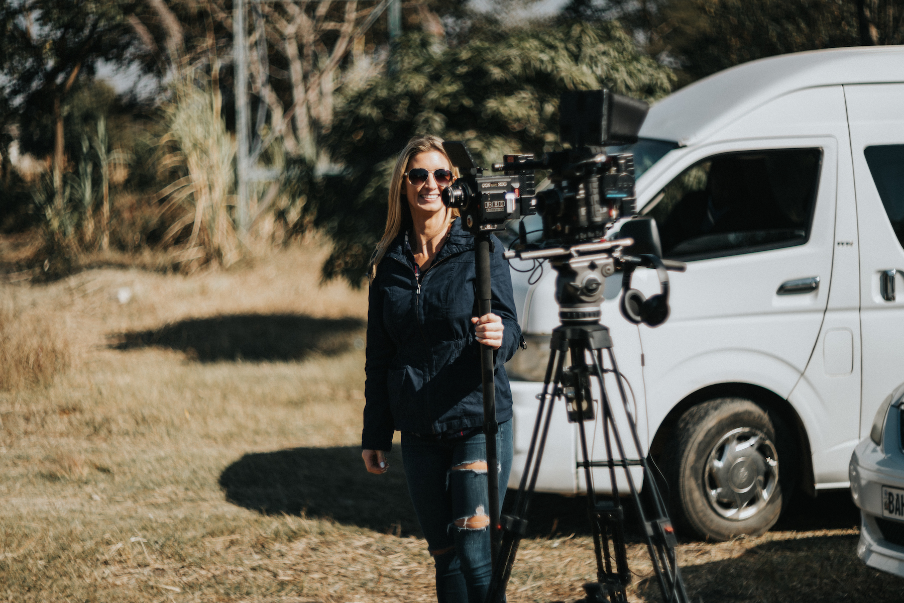 Marketing Woman with video equipment smiling for the camera