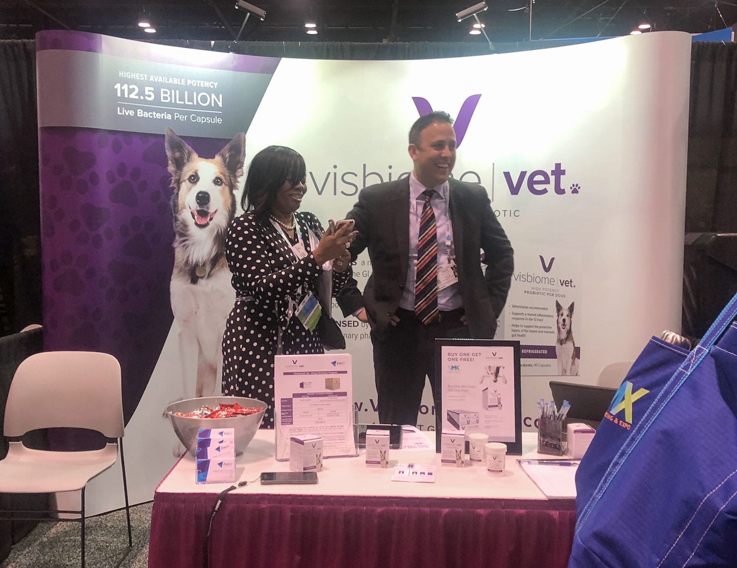 Booth for Visbiome Vet for High Potency Pet Probiotics with a woman and a man interacting with the public with promotion materials