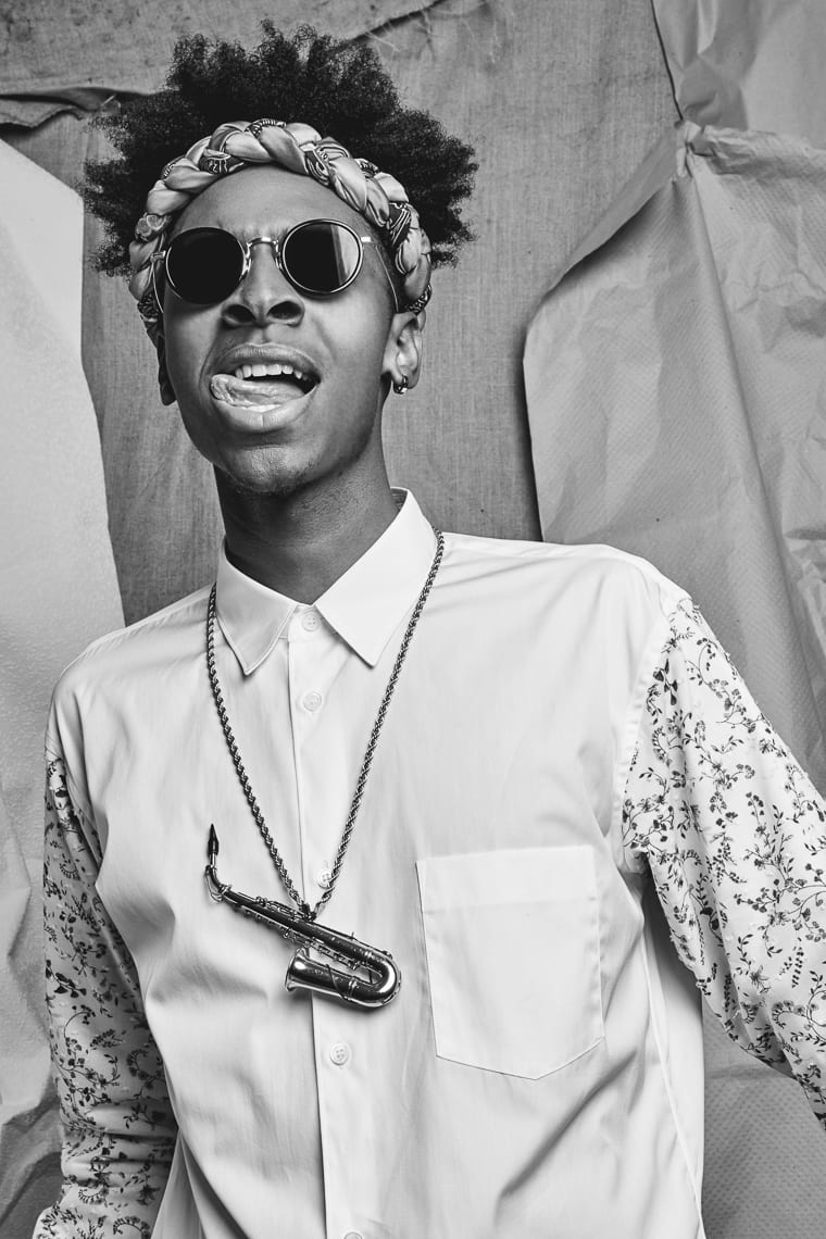 Masego Black and white of African American man posing for camera wearing shades and headband