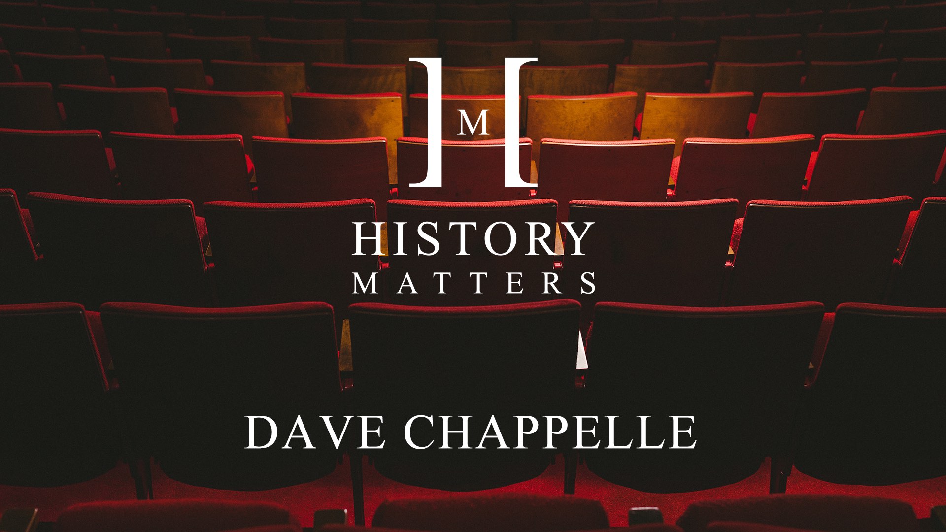 IU C&I Studios Page White HM Dave Chappelle logo with background showing movie seats in a movie theater