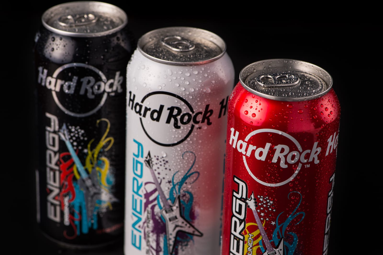 Closeup of three cans of Hard Rock Energy drinks on display