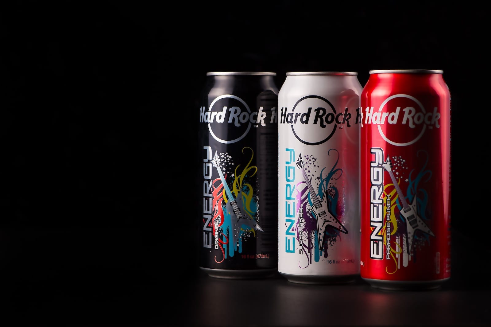 Three cans of Hard Rock Energy drinks on display