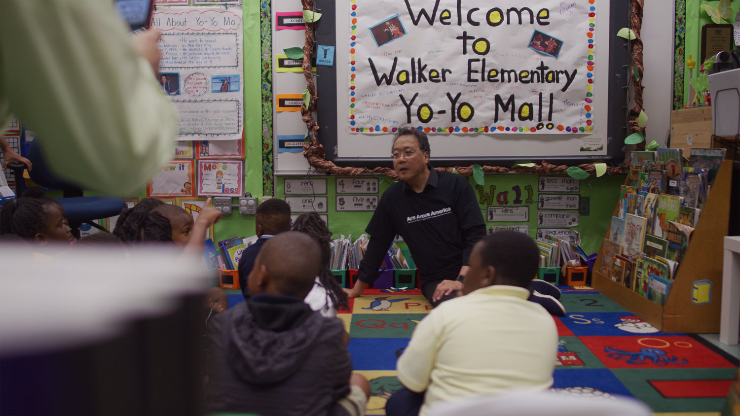 The Kennedy Center Man addresses a class of children in a classroom