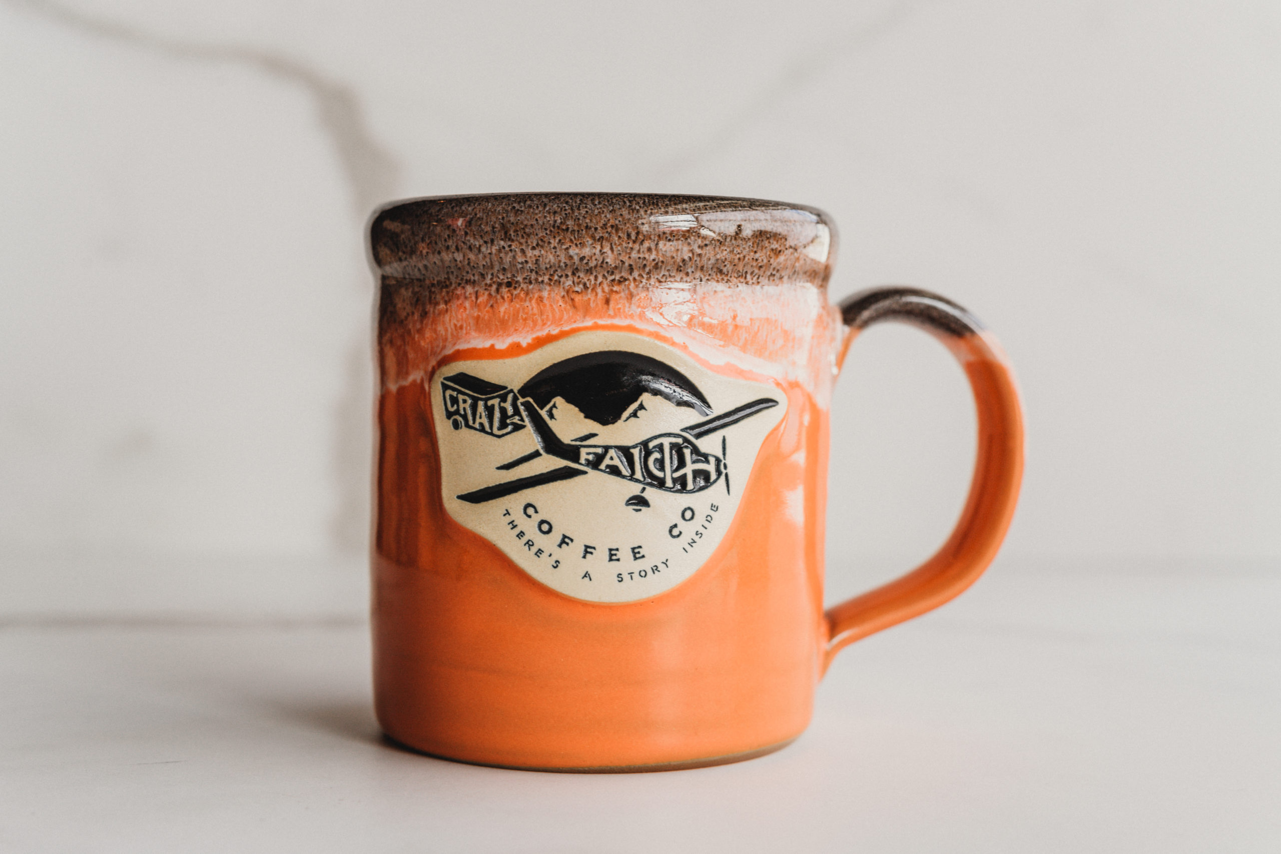 Orange and brown coffee cup