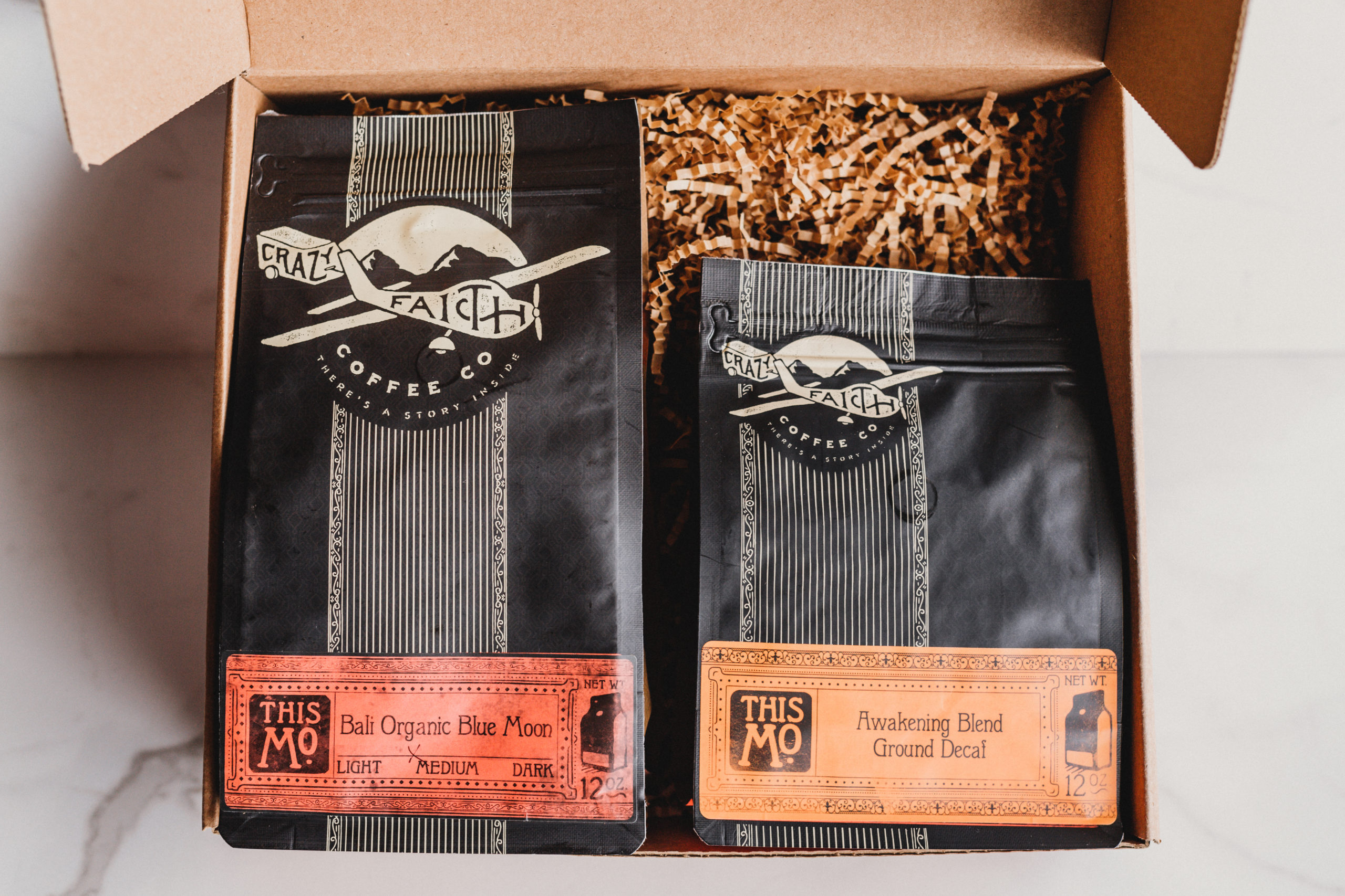 Packages of Bali Organic Blue Moon and Awakening Blend Groud Decaf coffee beans in a box