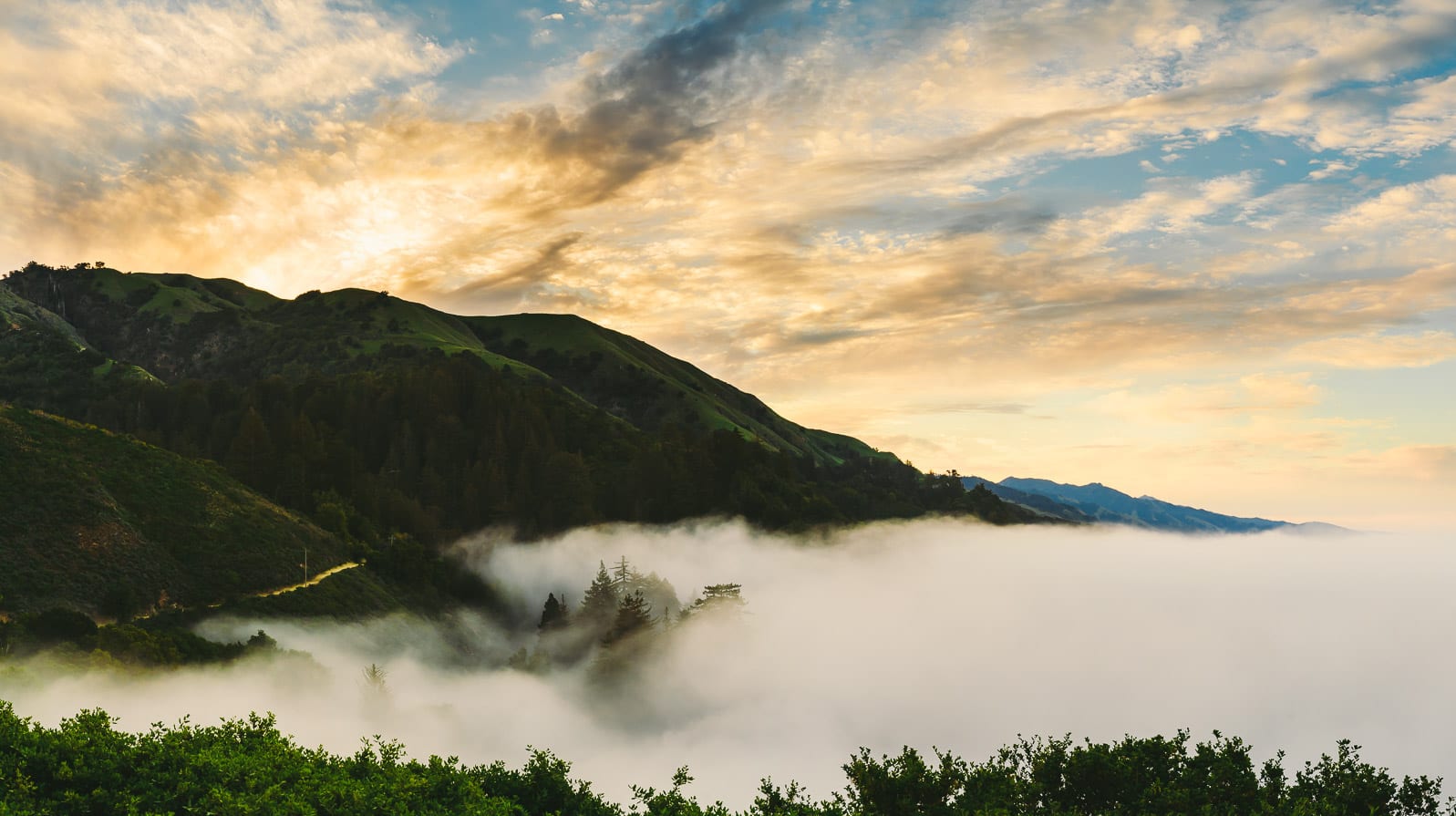 Landscapes of mountains and the sunset with fog below in the valley