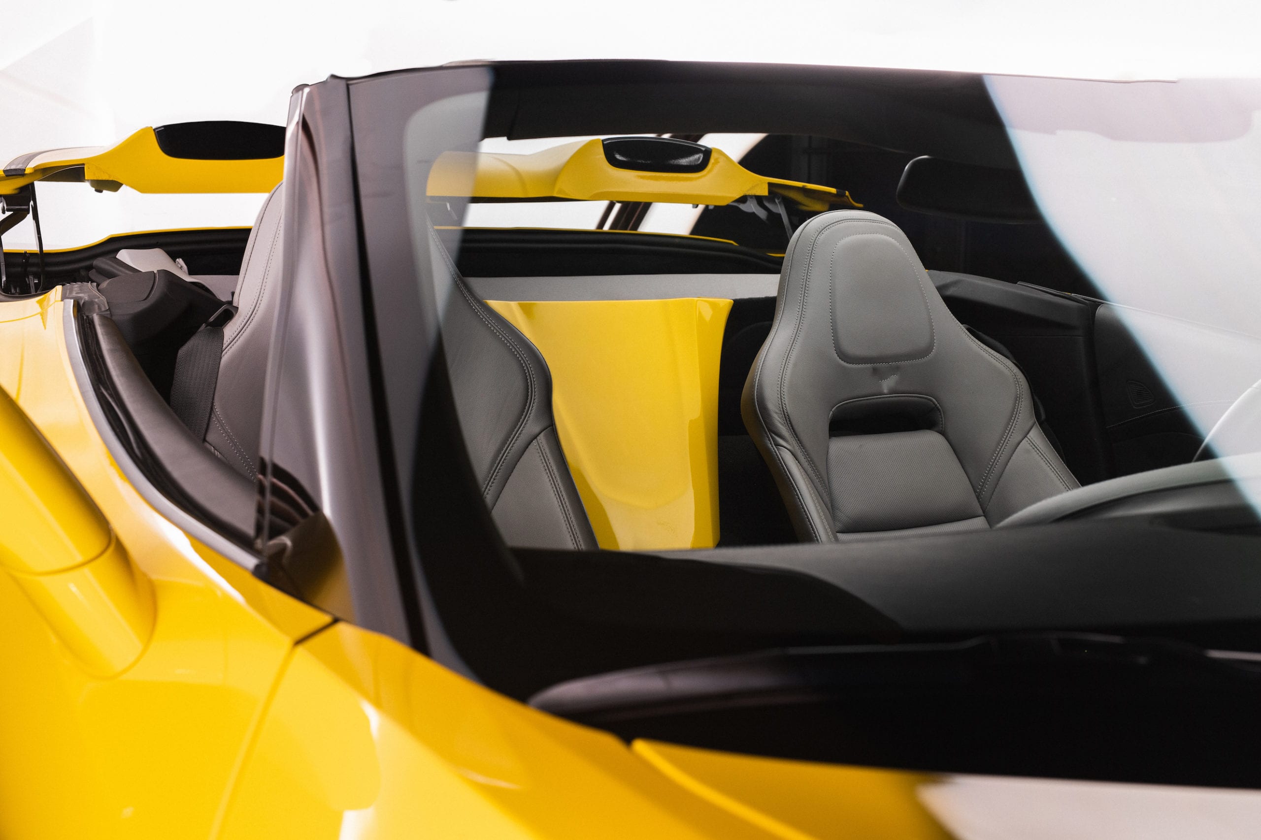 Interior of a yellow sports car with black leather
