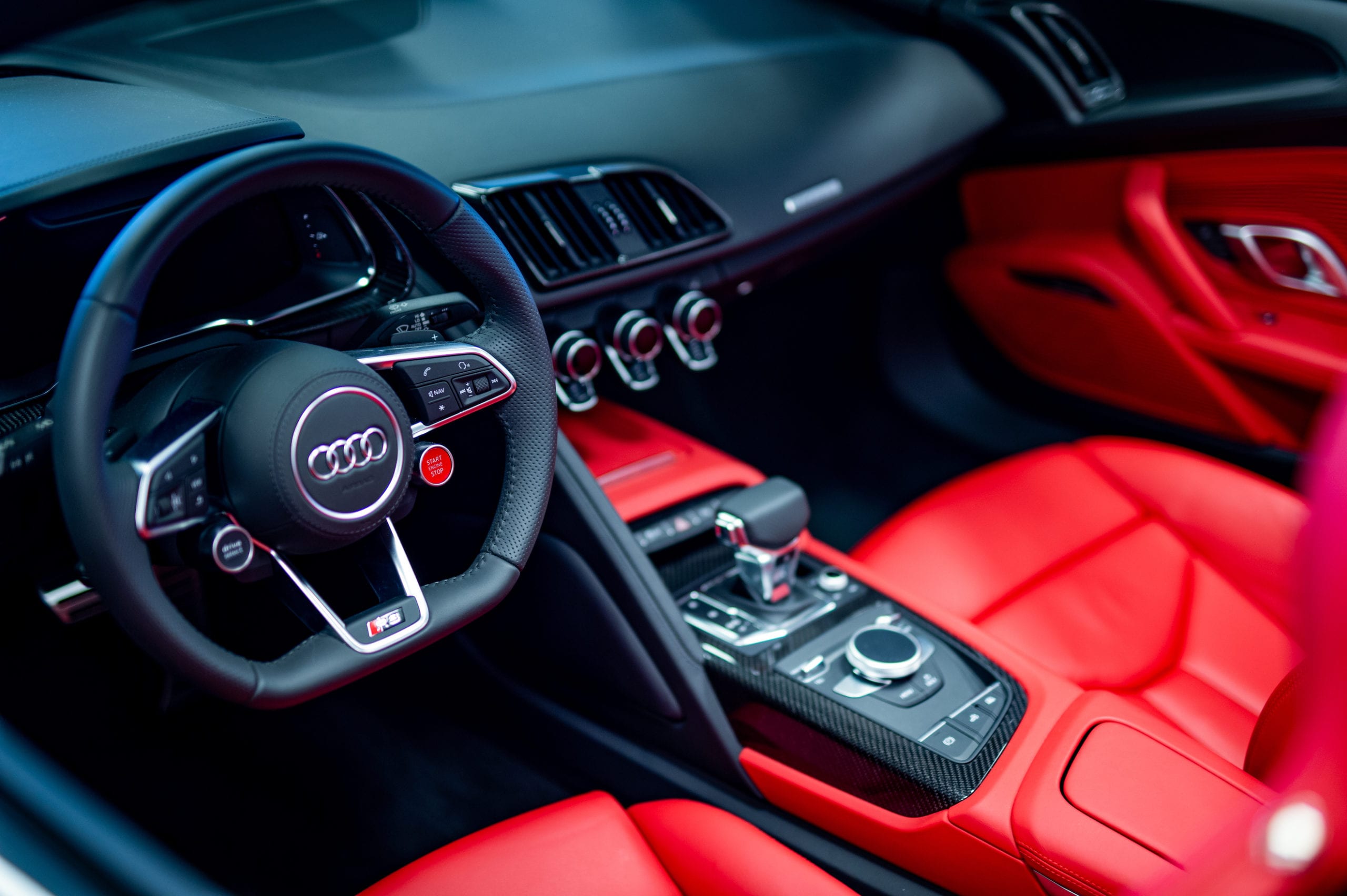 Interior view of a luxury Audi car with red leather seats