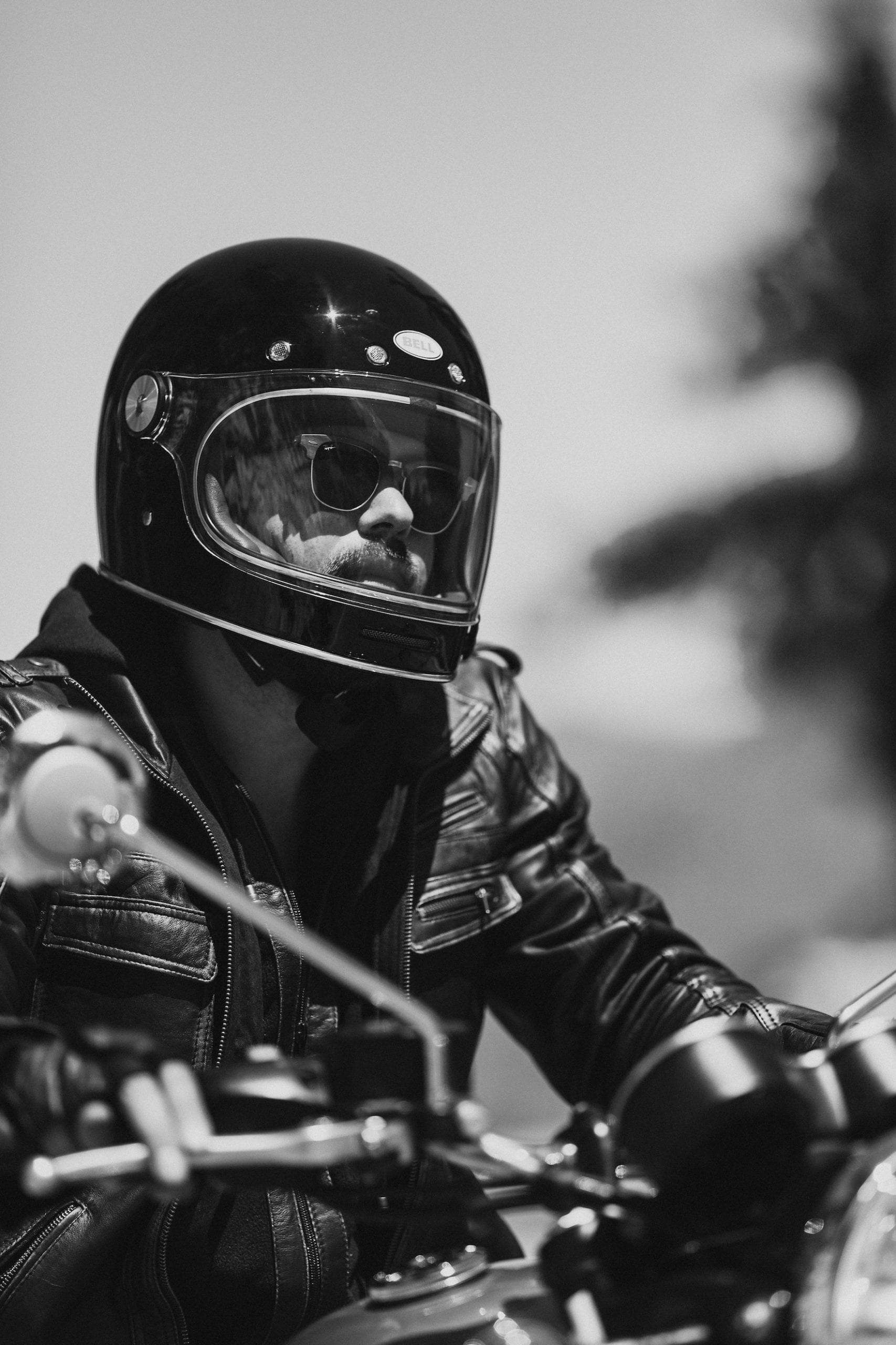 Black and white closeup of the motorcycle rider on his motorcycle