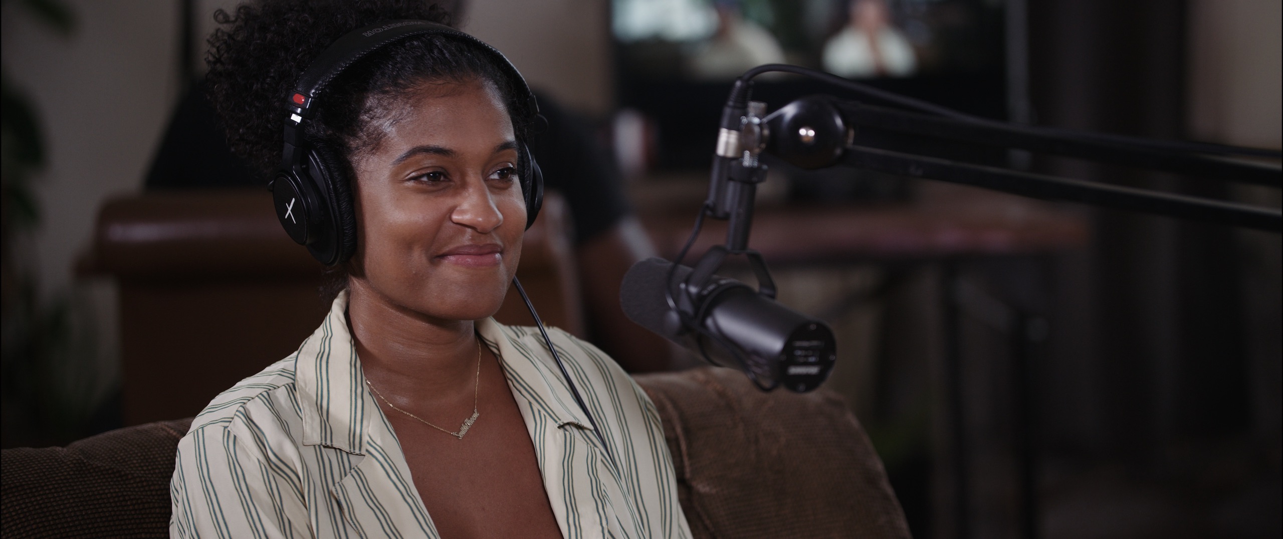 IU Uncreative Radio with Alexis Nichole Smith smiling by a microphone wearing headphones