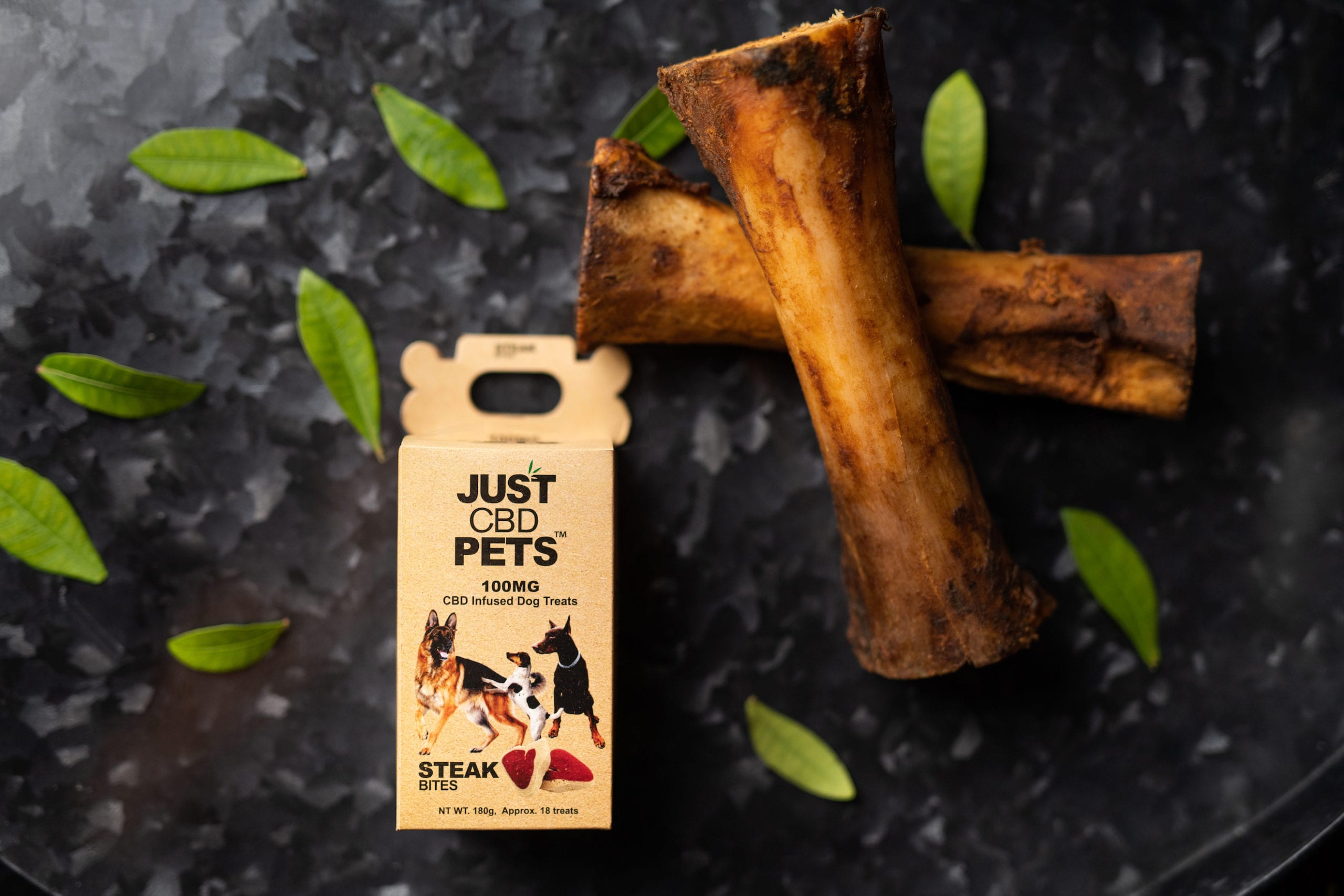 JustCBD Product Photography and Just CBD Products Steak bites pet treats with two bone marrows nearby