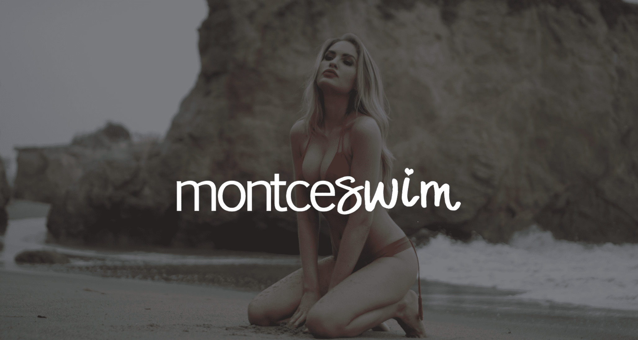 Professional Video Production Services by C&I Studios White montceswim logo against a dim background of a woman with long blond hair in a bikini kneeling in the sand posing for the camera