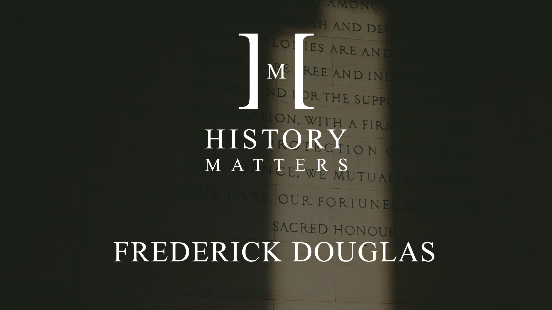 IU C&I Studios Page White HM Frederick Douglas logo with background of text on a stone wall