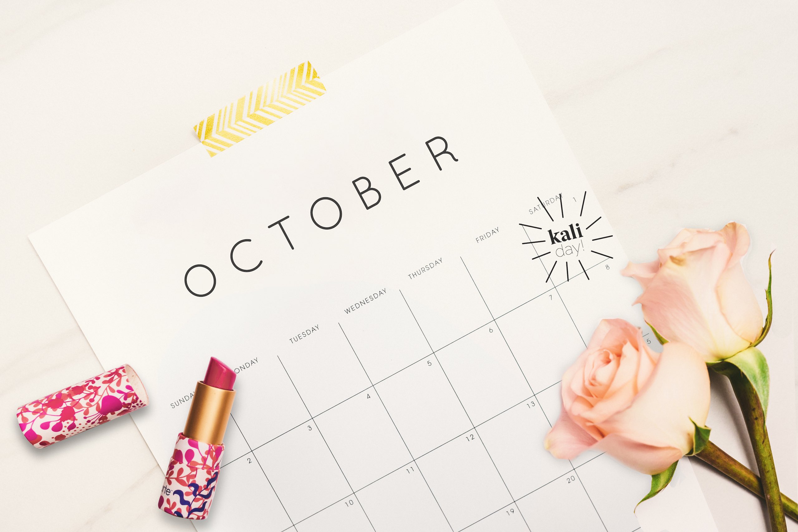 View of October Calendar with Kali Day entry with lipstick and pink roses