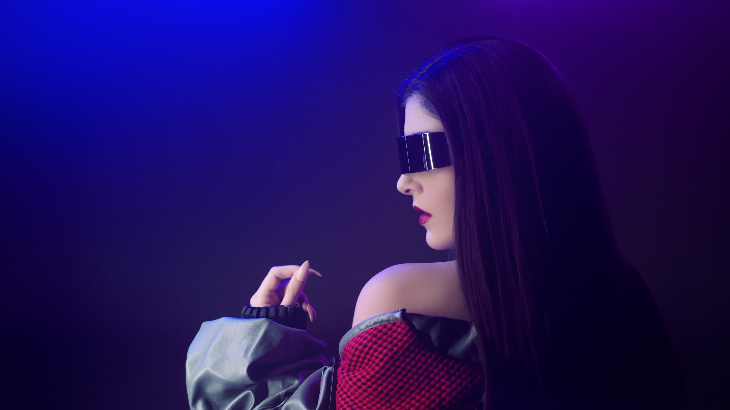 Audio Production View from behind of woman with long black hair wearing black shades and red and gray jacket