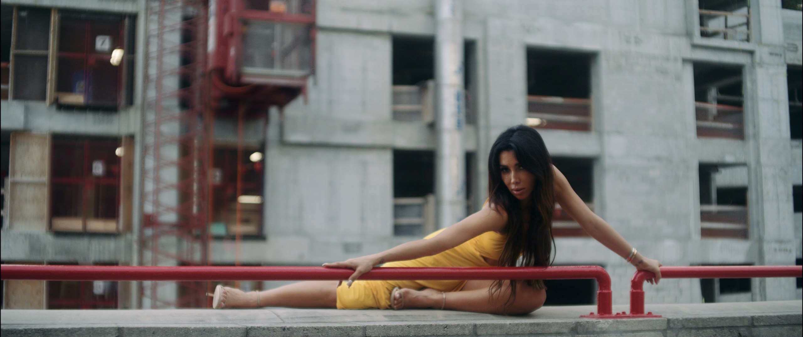 Metisha Model Profile from the Fort Lauderdale Talent Pool Metisha posing in a yellow dress on the ledge of building holding red railing