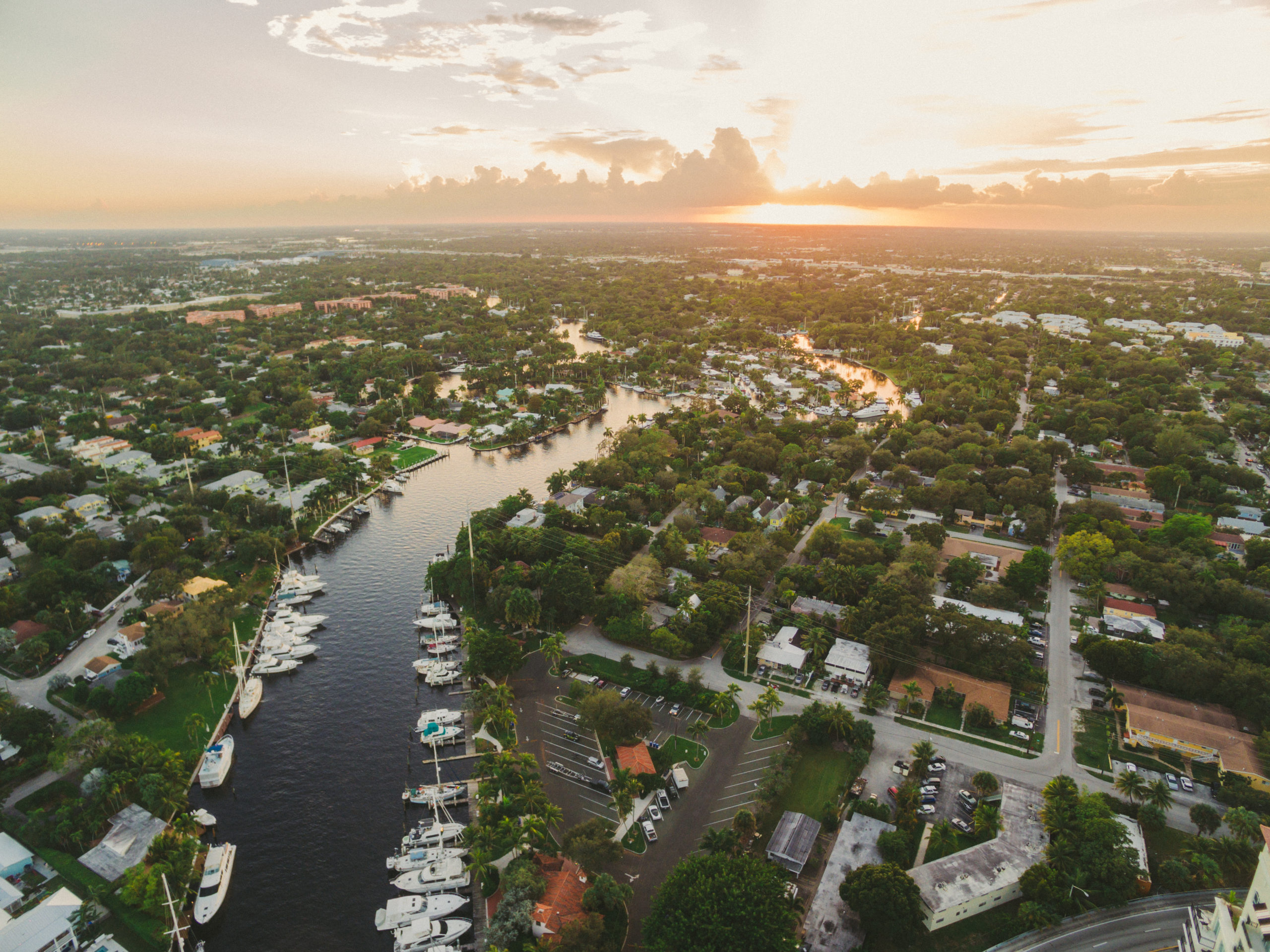 Footage in real estate Aerial view of canal with boats in a neighborhood
