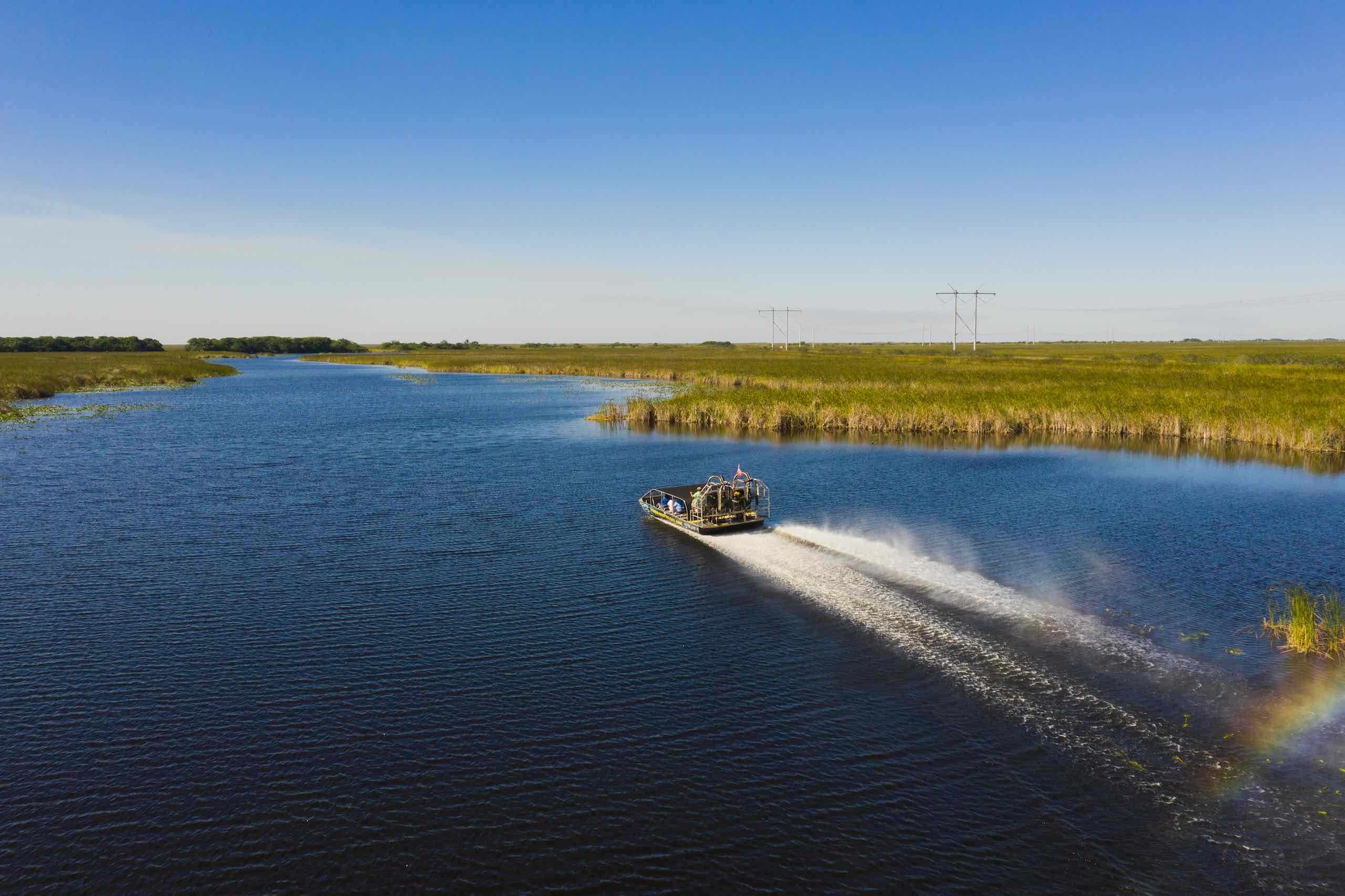 Everglades Holiday Park View from behind of an airboat cruising on the water