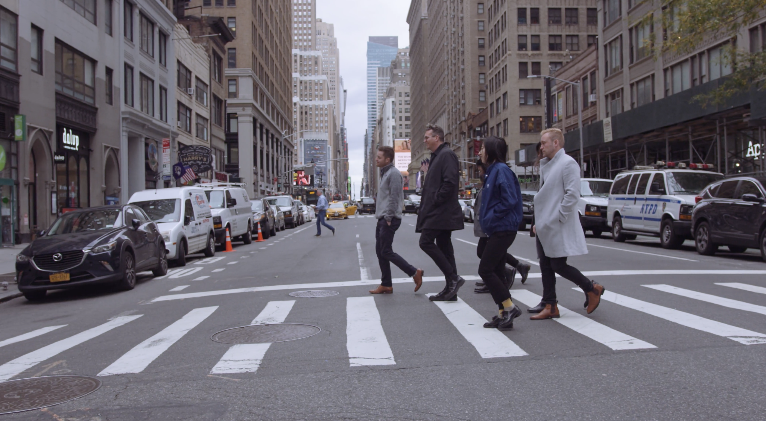 IU EDSA Design Studio NYC Three men and two women walking across a city street on a crosswalk