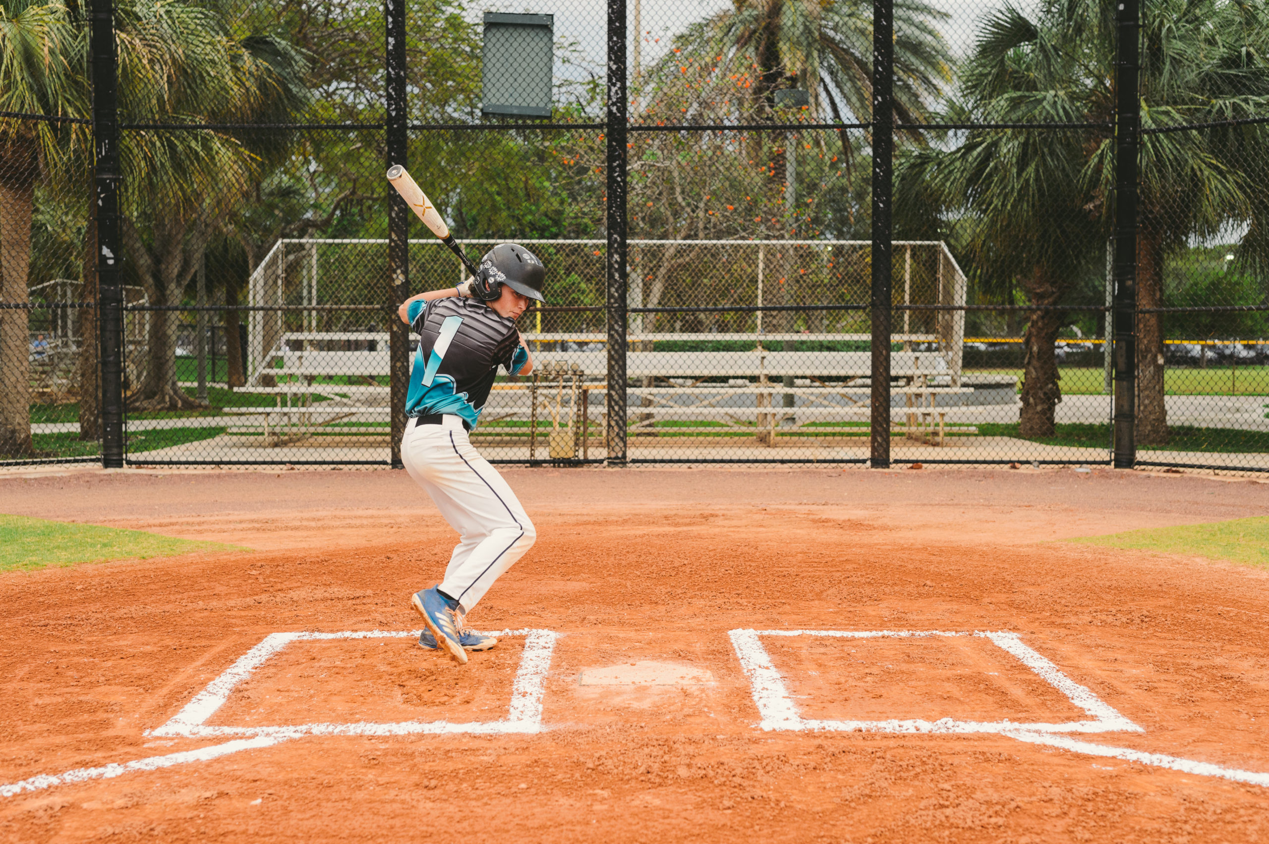 Young baseball player in a batting pose on a baseball field