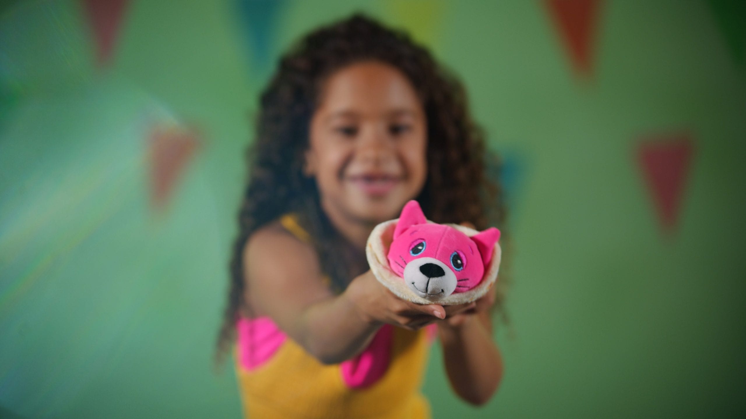 Closeup of stuffed animal being held by a smiling girl