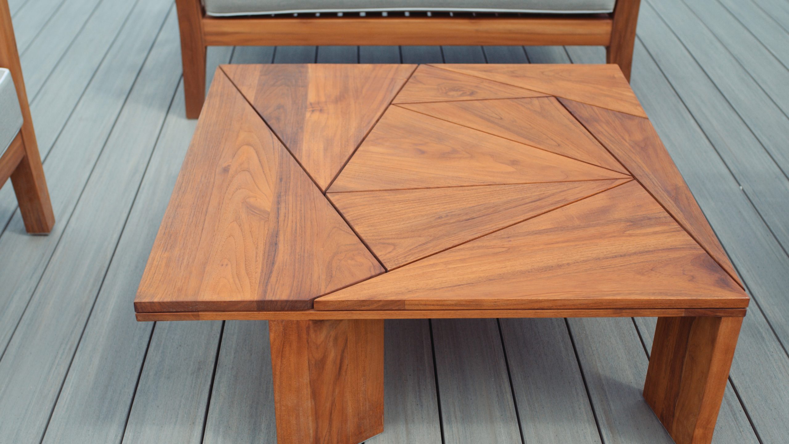 Closeup of a wooden table with chairs around it