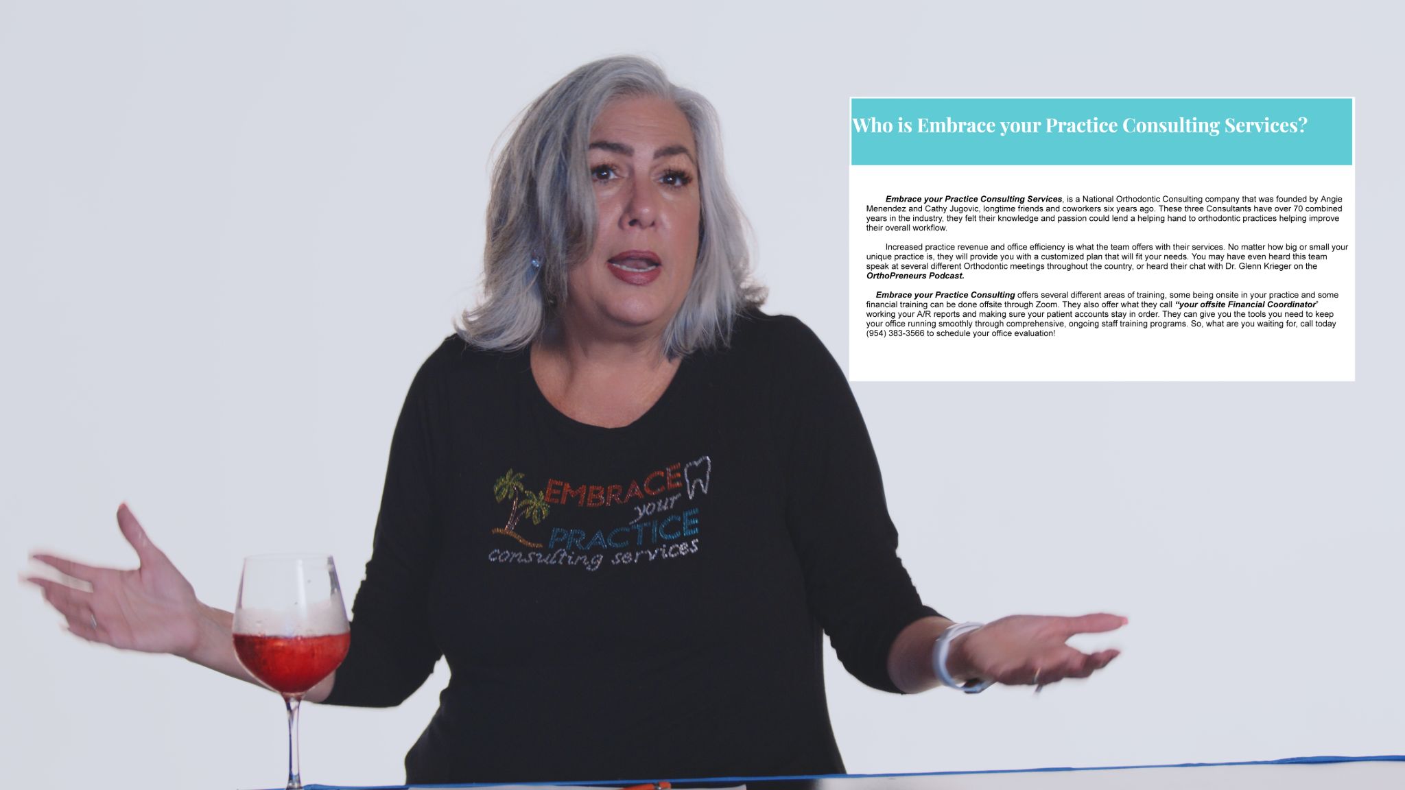 Woman with gray hair talking wearing black shirt with colorful logo with a glass of red wine nearby and Who Is Embrace Your Practice Consulting Services insert