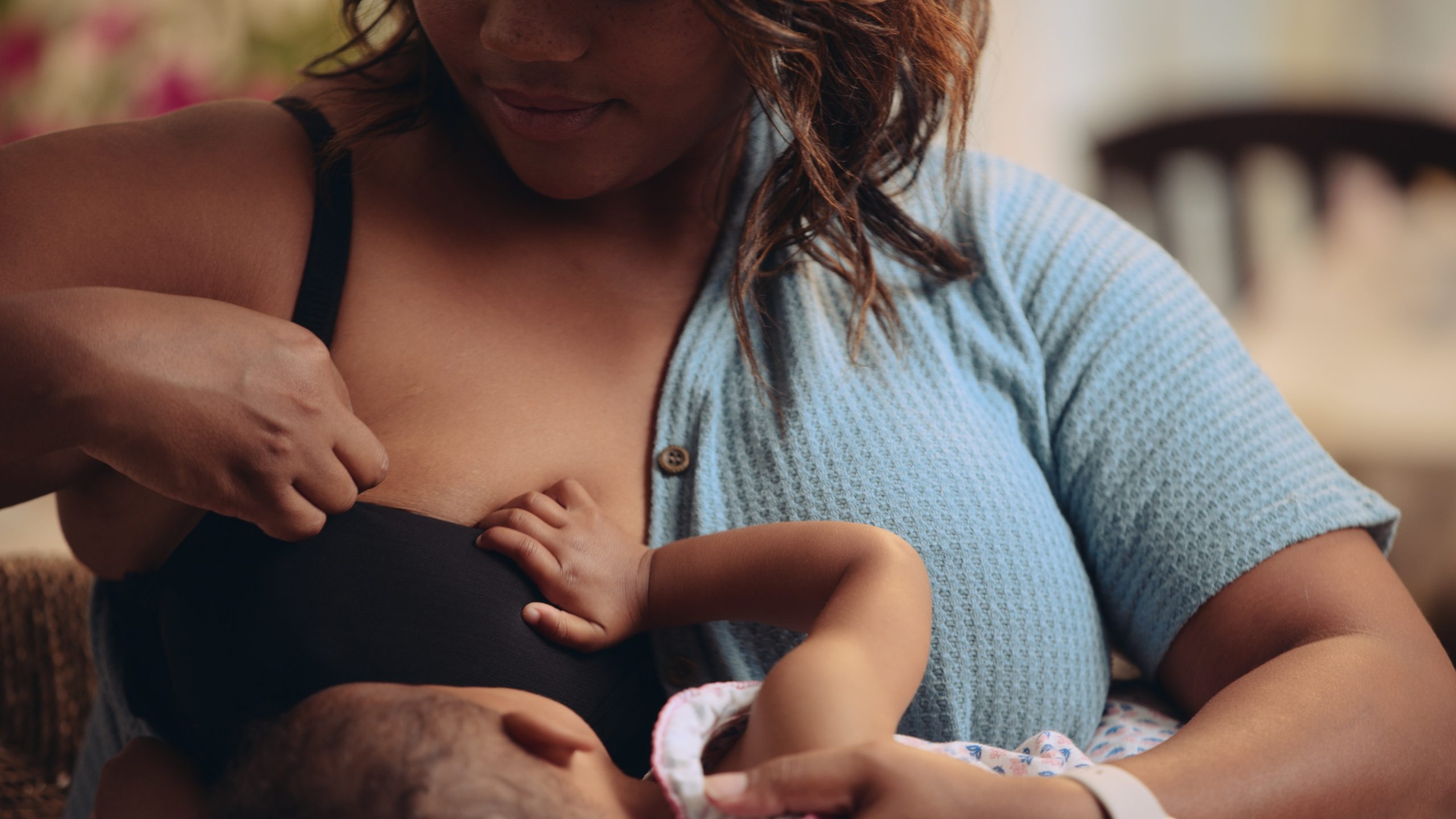 JennaBra Closeup of woman breastfeeding a baby wearing the black bra