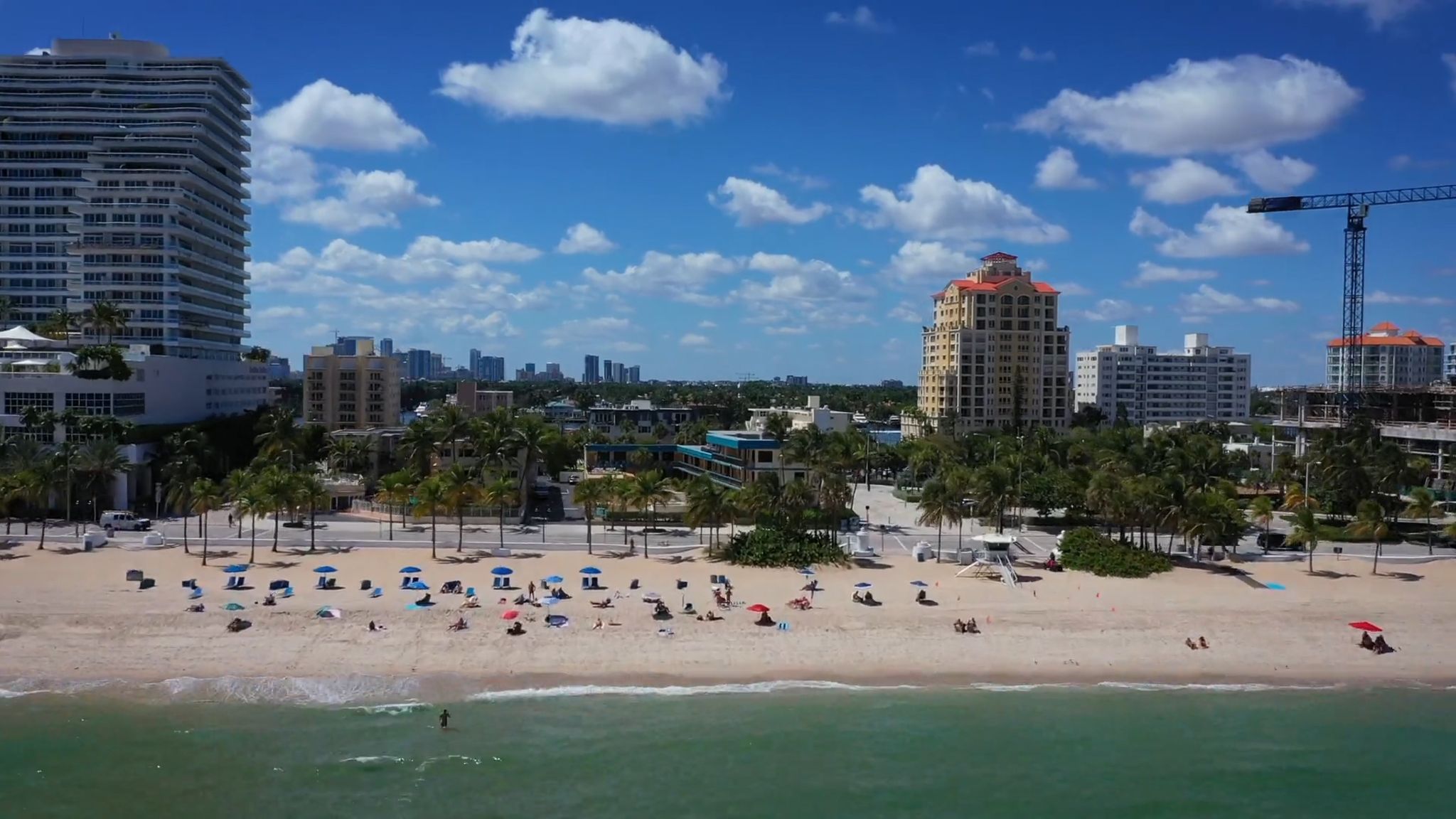Aerial view of a beach with buildings in the background
