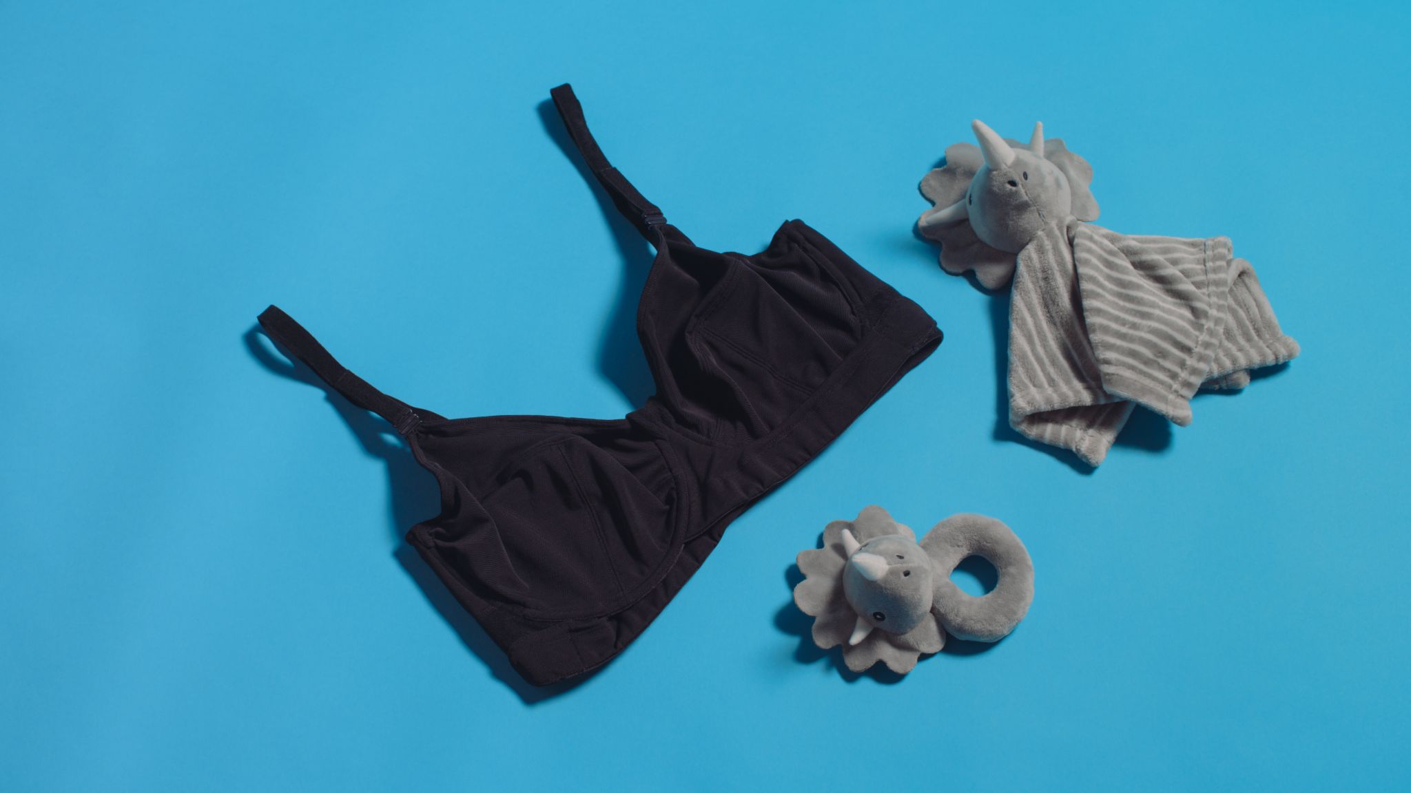 JENNAbra Product Flatlays Black bra on display with two stuffed toy elephants