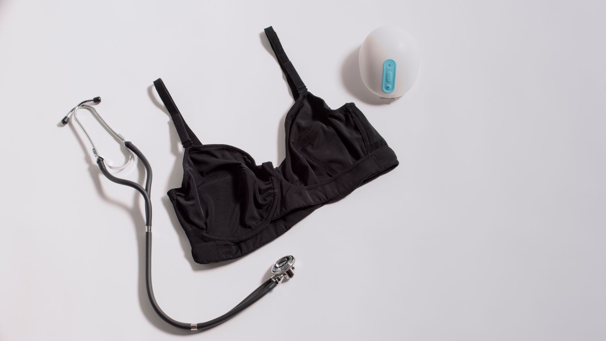 JENNAbra Product Flatlays Black bra on display with stethoscope and device