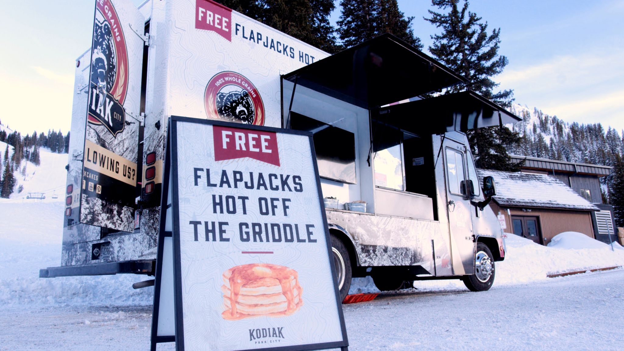 IU C&I Studios Portfolio Newbridge Marketing Kodiak Cakes View of company van and ad for free flapjacks in front of it