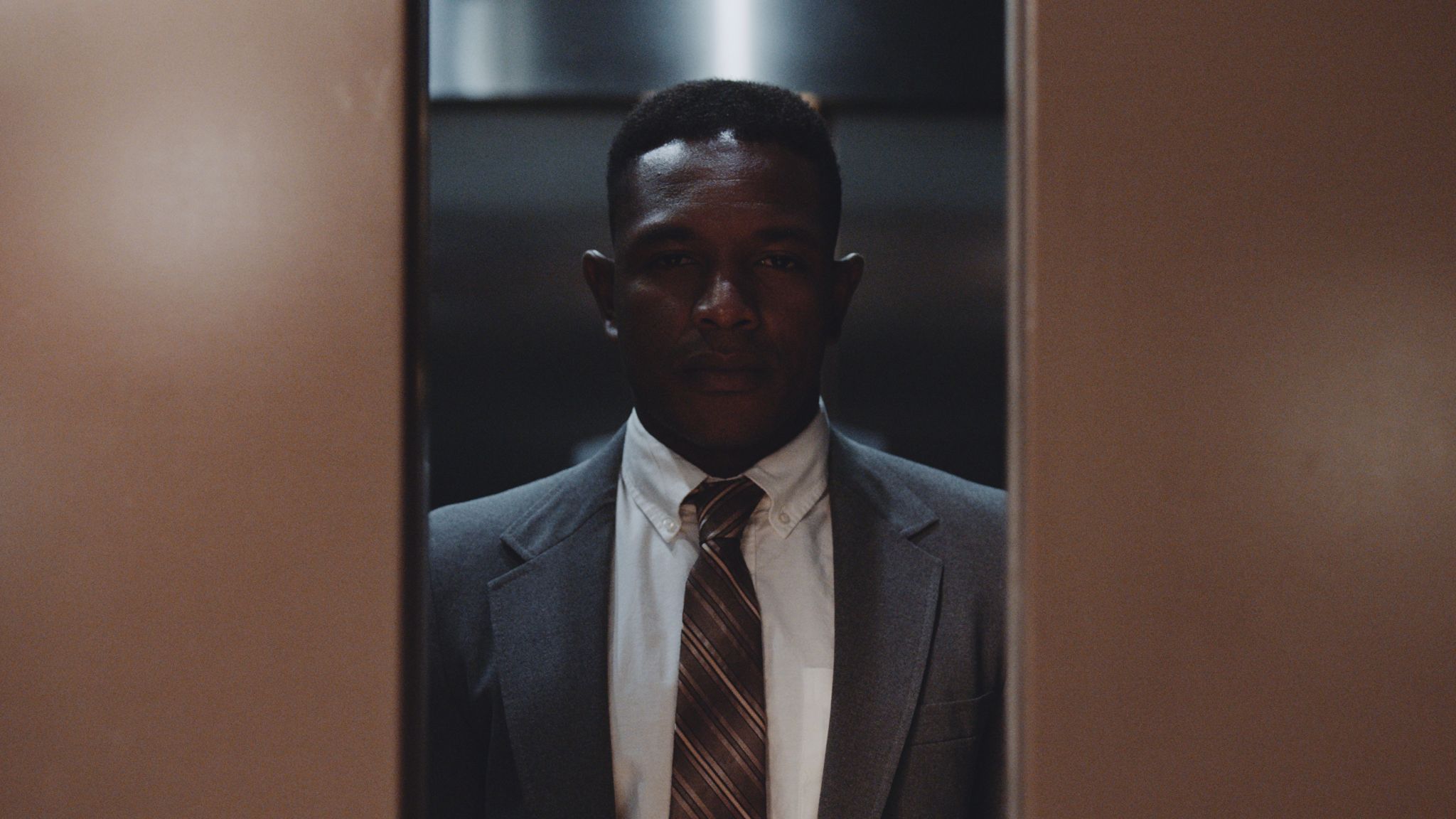 When should I start using video for my business African American man in suit looking through elevator doors