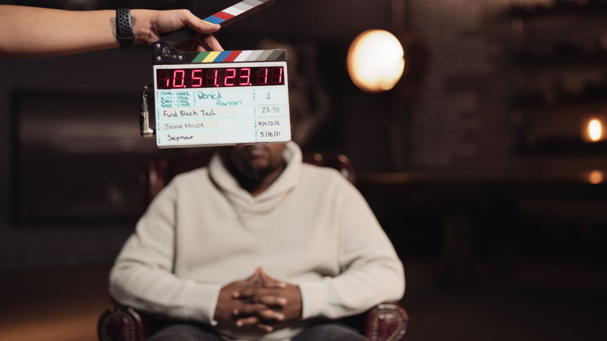 8K Fund Black Tech Derrick View of clapboard being used in front of him before shoot