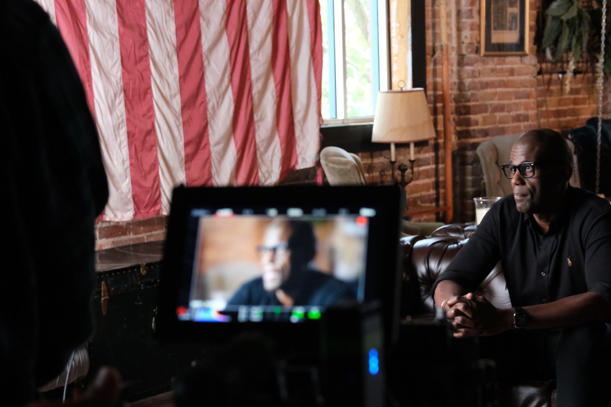 Image from set of What Is a Hybrid documentary African American man being filmed on a set looking off to the side