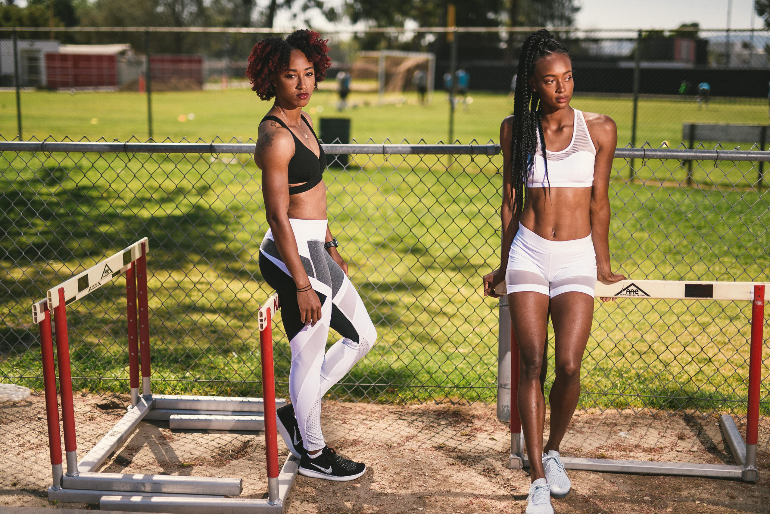 Professional Photography Services to elevate your brand C&I Studios Creative Marketing Kinetix 365 Two women posing for the camera on a track leaning on hurdles