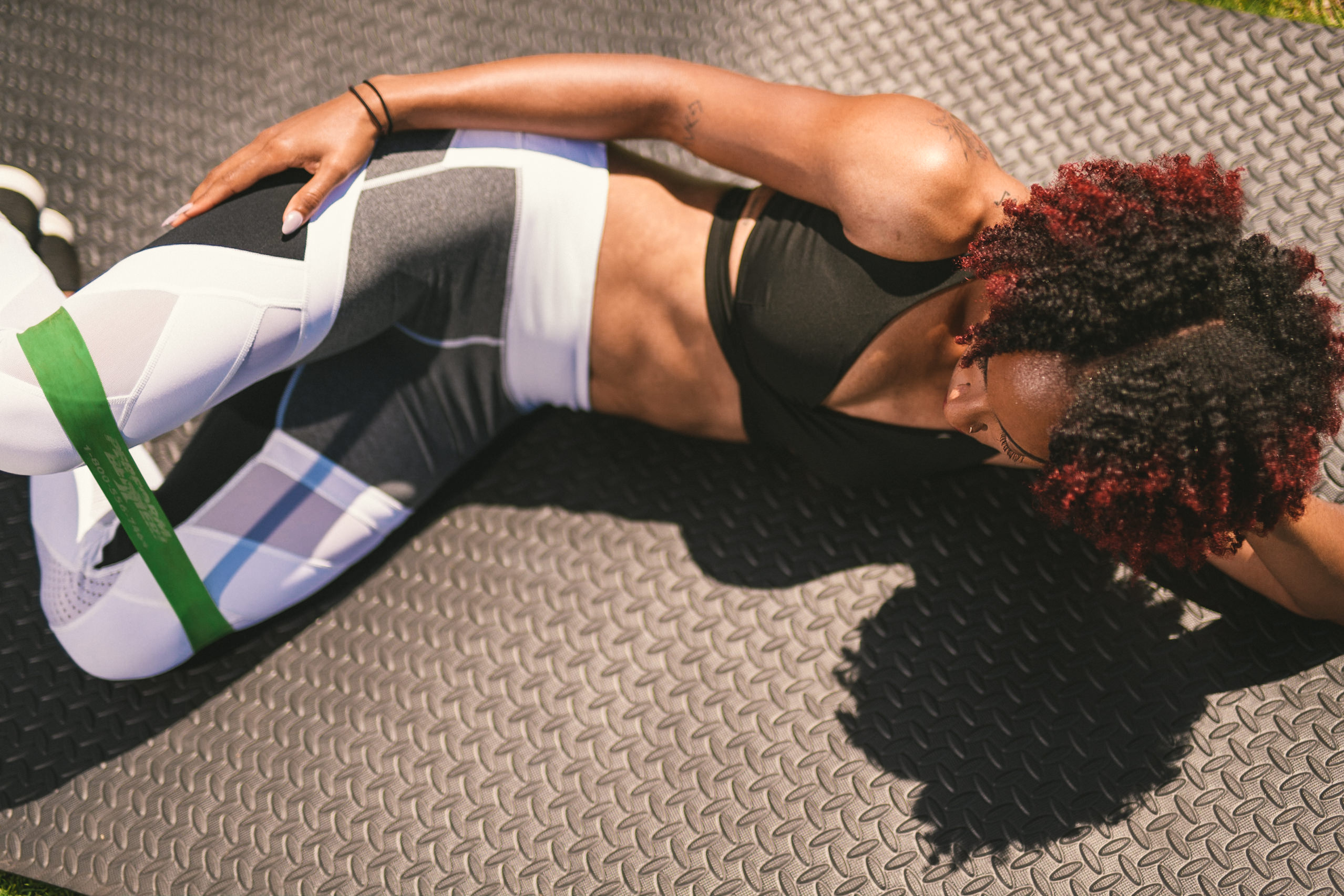 Professional Photography Services to elevate your brand C&I Studios Creative Marketing Kinetix 365 View from above of woman doing stretches with rubber band in track outfit