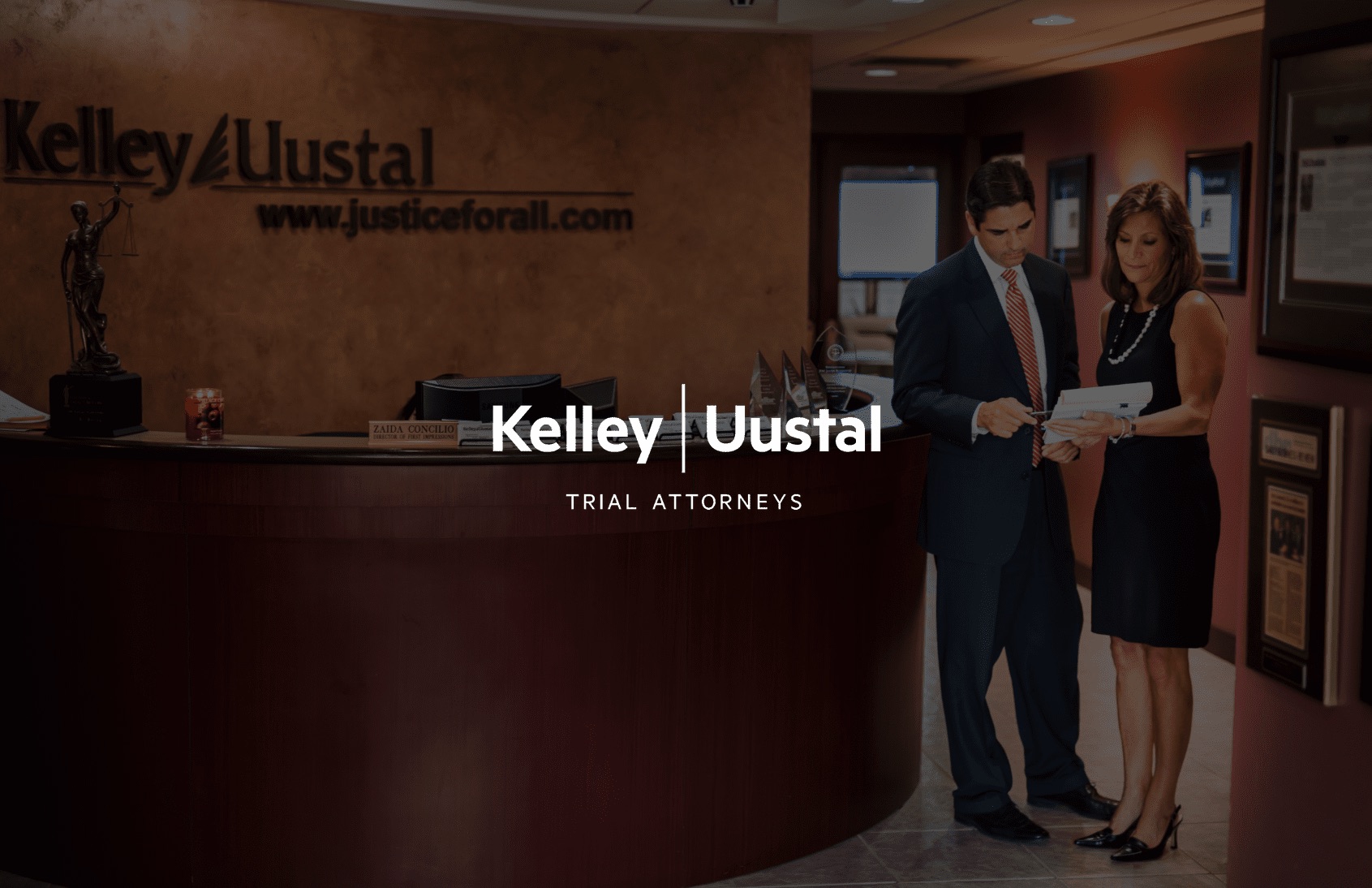 IU C&I Studios Page Kelley & Uustal Trial Attorneys logo with a male and female attorney going over a case in a lobby in the background