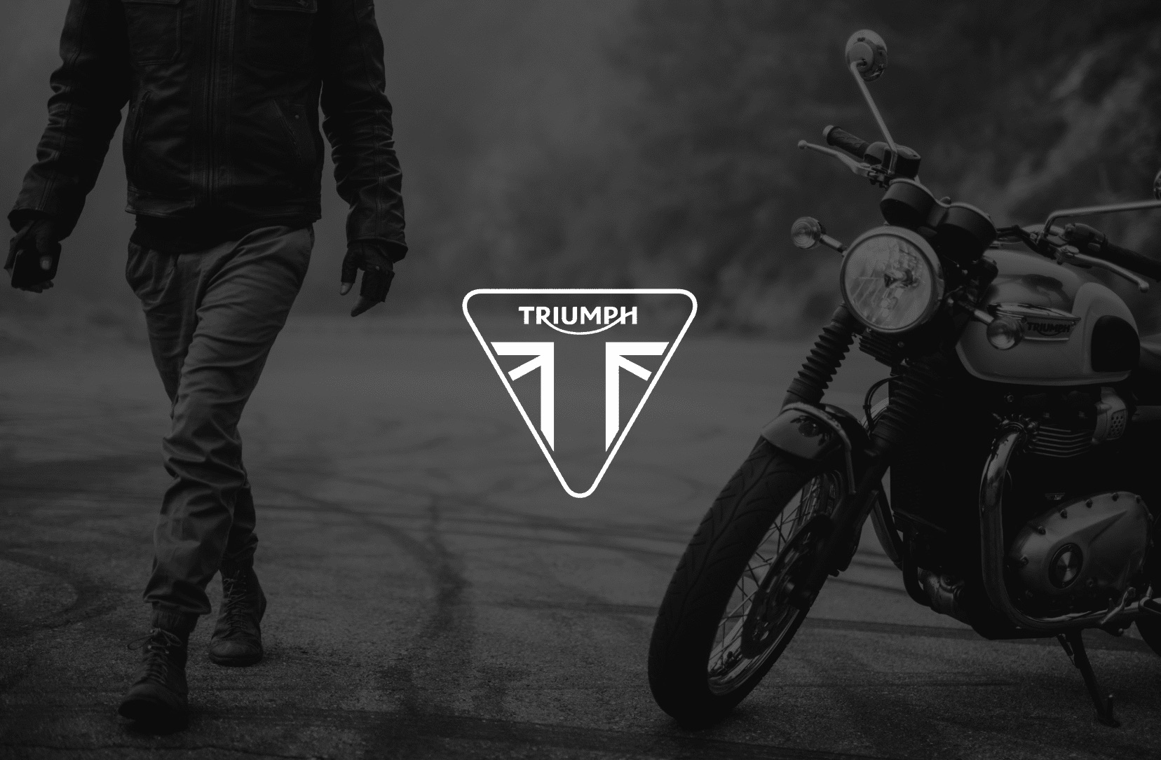 IU C&I Studios Page White Triumph logo with black and white photo of the rider walking away from the Bonneville T100 in the background