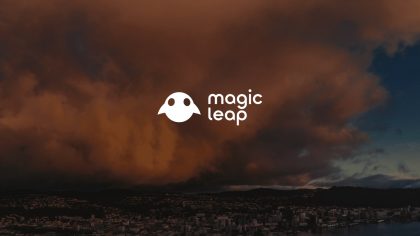 IU C&I Studios Page White Magic Leap Logo With Graphic Ghost Image With Reddish Orange Cloud Over City In The Background