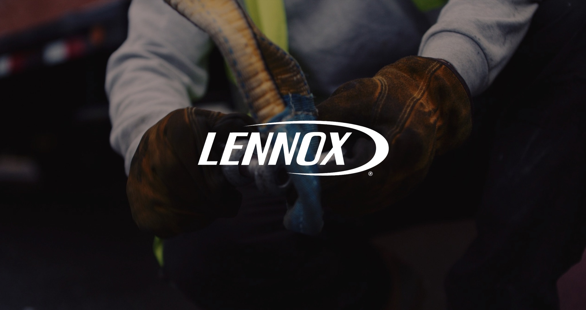 IU C&I Studios Page Lennox Heating & Cooling White Lennox logo with background closeup of leather gloved hands working with fastener