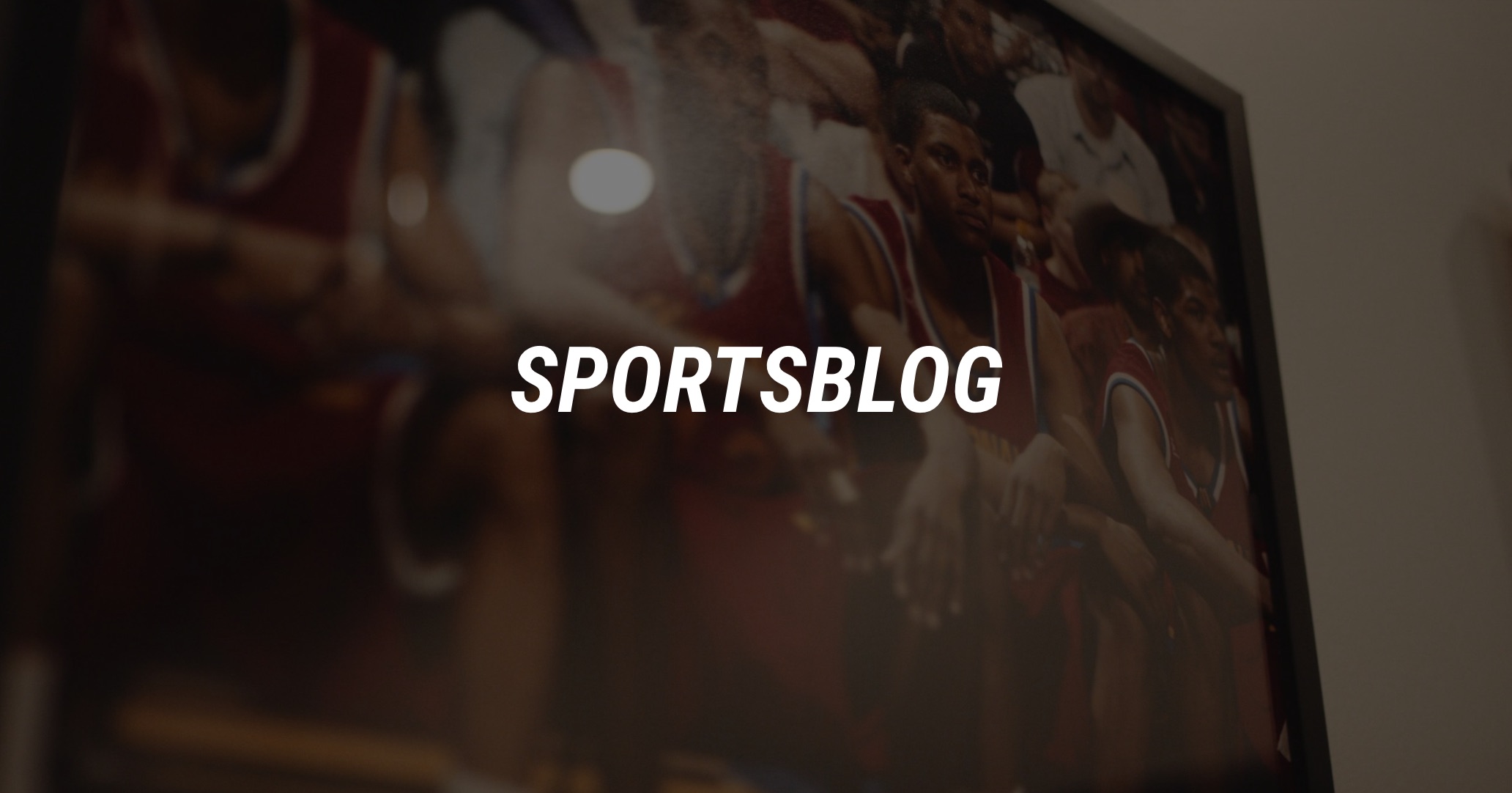 White Sportsblog logo, a documentary mini series with background of a photo showing basketball players wearing red jerseys sitting on a bench