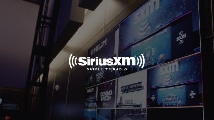 White Sirius XM Satellite Radio Logo With Dimmed Background Of Video Bank