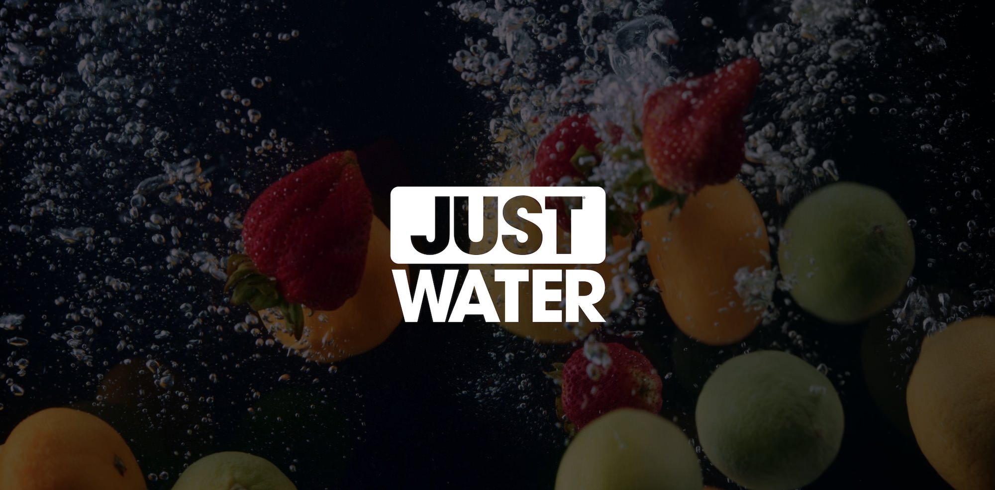 White Just Water Logo Marketing by C&I Studios with dimmed background of fruit and bubbles underwater