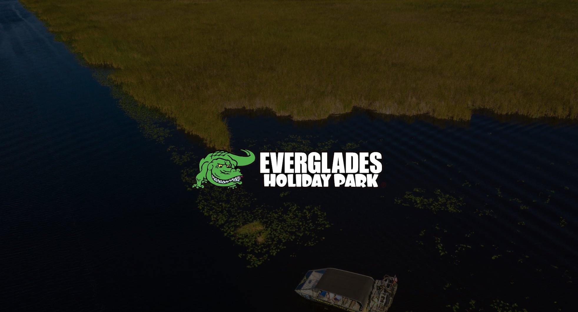 IU C&I Studios Page Green and white Everglades Holiday Park logo Social Media Marketing by C&I Studios over a dimmed background aerial view of an airboat on the water