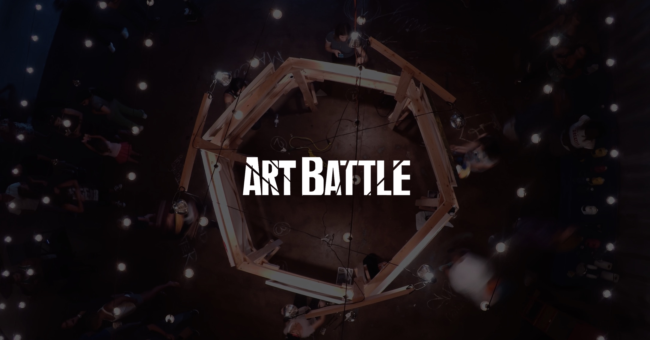 IU C&I Studios Page White Art Battle logo on dimmed background aerial of live painting competition