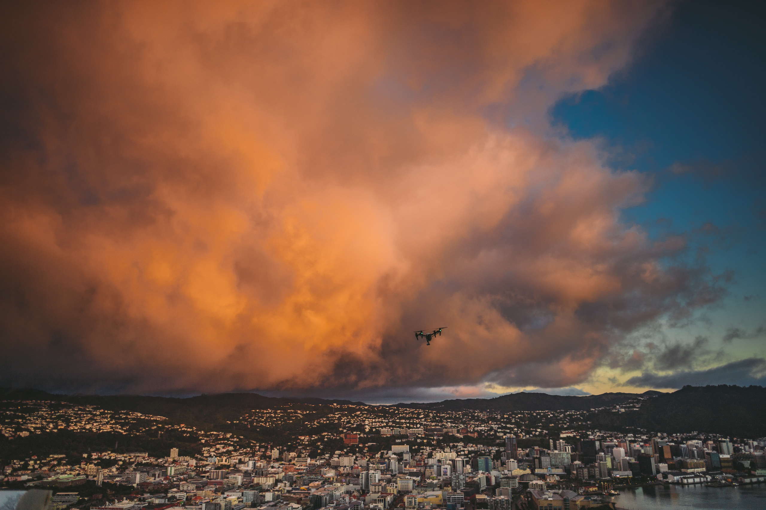 Drone in the sky over the valley with reddish clouds in the background