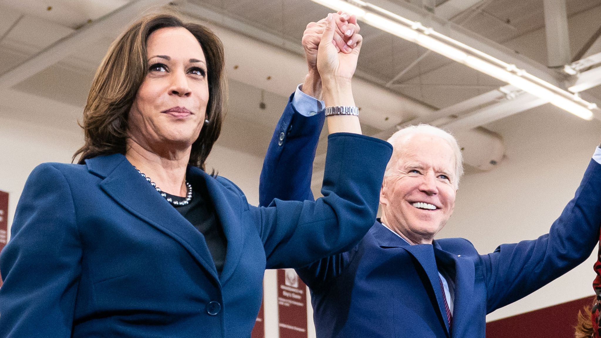 We Did That Headshot of Joe Biden and Kamala Harris holding hands up in celebration